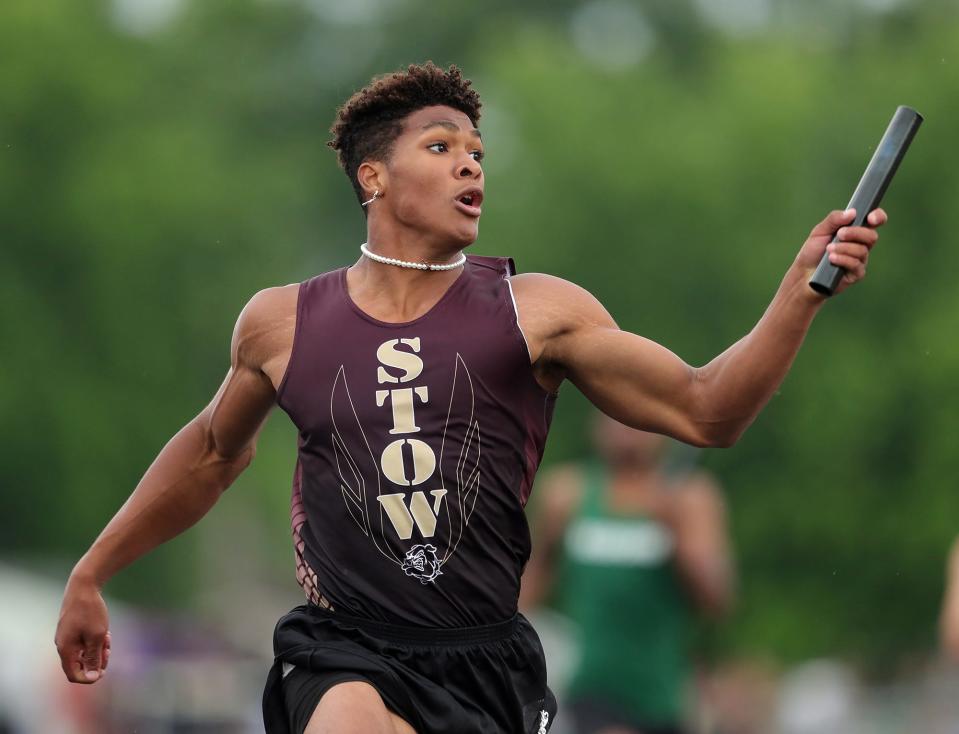 Stow's Xavier Preston looks to the timer as he helps the Bulldogs set a school record in the boys 800-meter relay race with a time of 1:26.85 during the Division I regional track and field meet at Austintown Fitch High School on Friday.