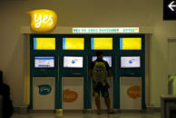 FILE PHOTO: A customer uses an OPTUS internet facility at Sydney International Airport, Australia, November 8, 2015. REUTERS/David Gray/File Photo