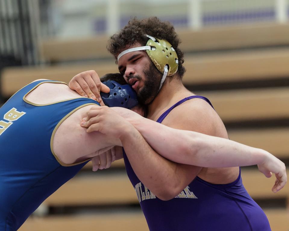 Fowlerville's George Daniel (right) defeated Chelsea's Donavan Fisk at 285 pounds in the team district final on Wednesday, Feb. 8, 2023.