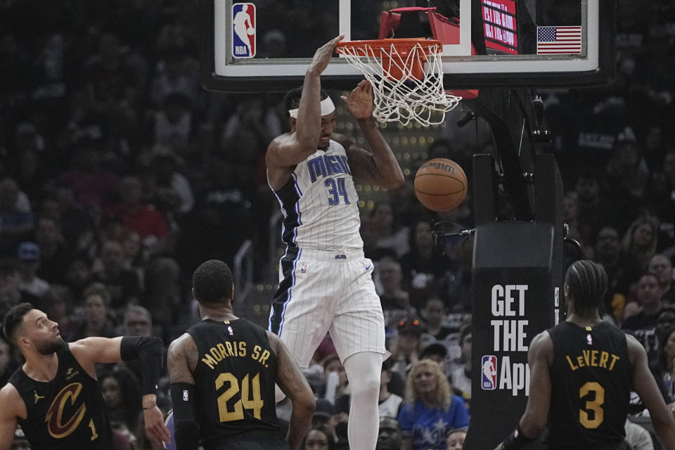 Orlando Magic center Wendell Carter Jr. (34) dunks in front of Cleveland Cavaliers guard Max Strus (1), forward Marcus Morris Sr. (24) and guard Caris LeVert (3) in the first half of Game 7 of an NBA basketball first-round playoff series Sunday, May 5, 2024, in Cleveland. (AP Photo/Sue Ogrocki)