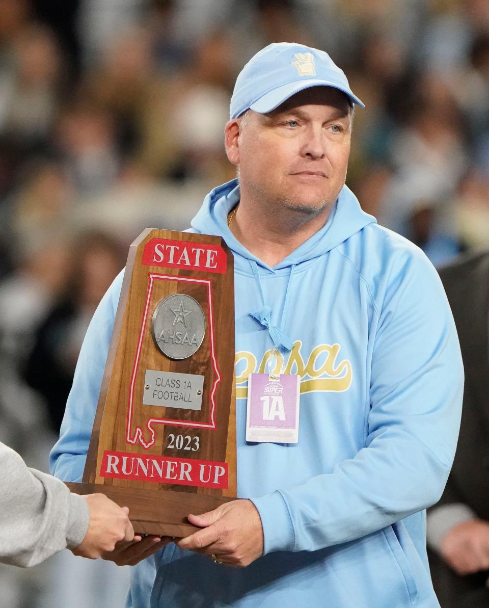 Coosa Christian head coach Mark O'Bryant accepts the runner up trophy following the 1A AHSAA State Championship Game in Bryant-Denny Stadium Thursday, Dec. 7, 2023, in Tuscaloosa. Leroy defeated Coosa Christian 28-21.