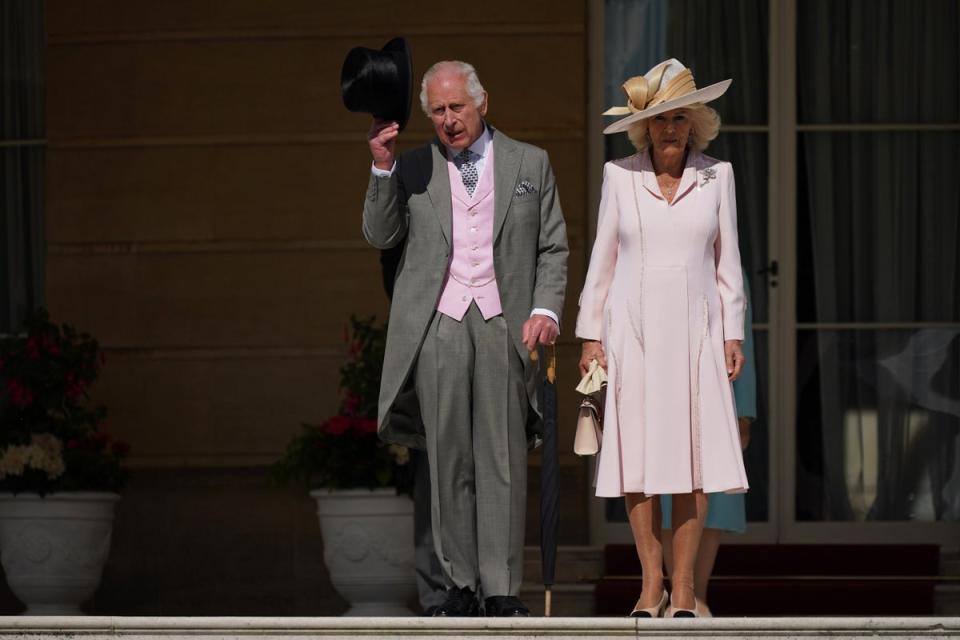 The King and Queen arrive at the garden party with a touch of pink (Aaron Chown/PA Wire)