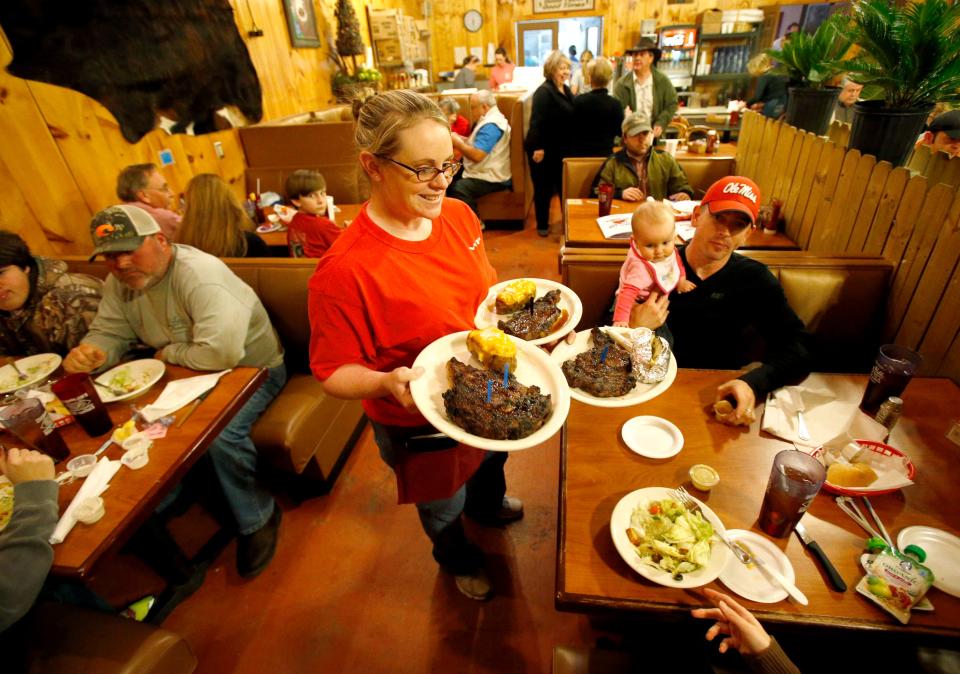 Sarah Knight serves up a customer's order at Diamond Jim's and Mrs. Donna's restaurant in Livingston on Feb. 7, 2014.