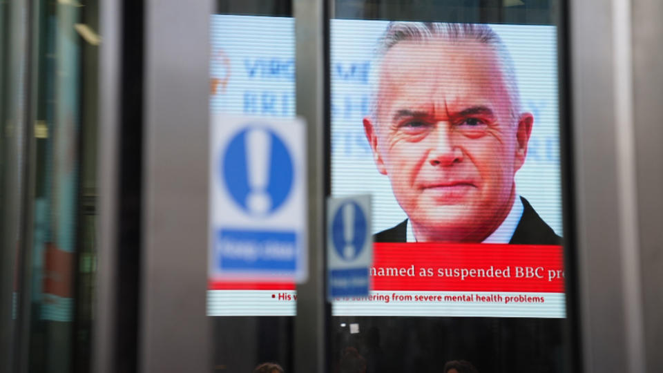 A screen in BBC Broadcasting house, in central London, displaying presenter Huw Edwards who was named by his wife Vicky Flind as the BBC presenter suspended following allegations that he paid a teenager tens of thousands of pounds for sexually explicit images in a statement issued on his behalf.