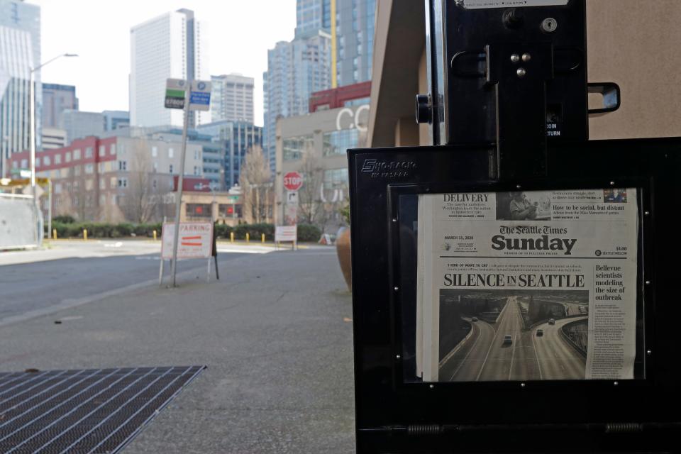 A Seattle Times headline reading "Silence in Seattle" eerily sits next to an empty street just outside the Times' newsroom.