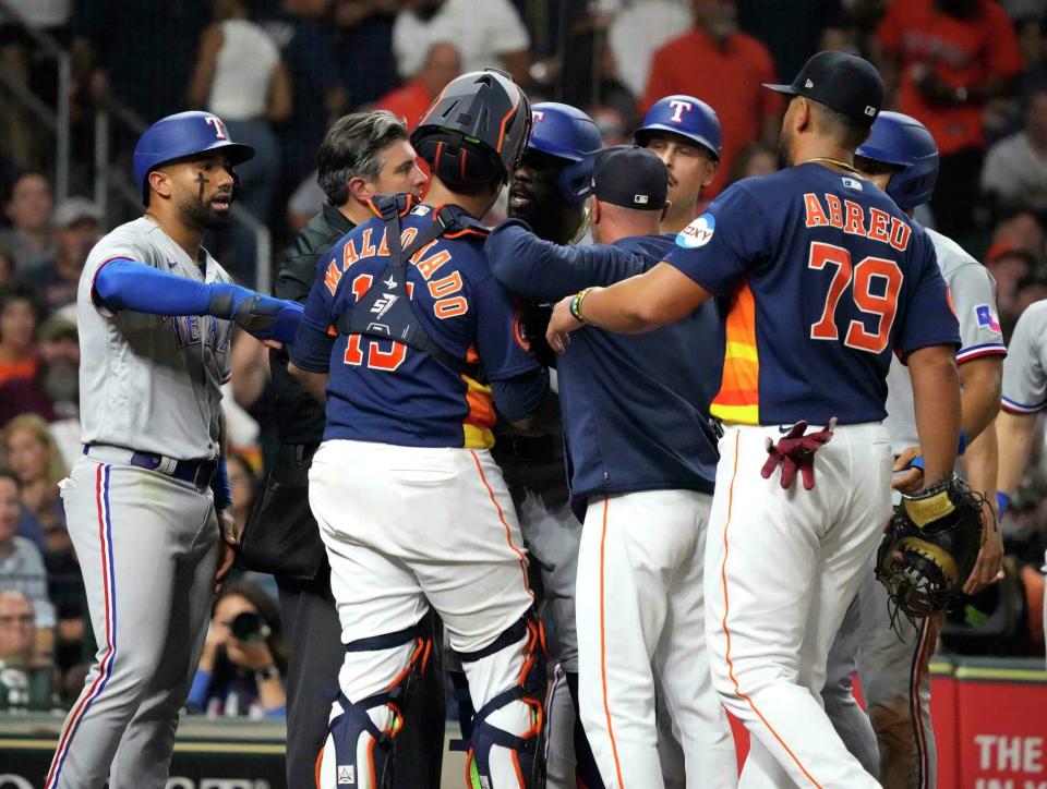 The Rangers' Adolis Garcia steps into a confrontation with Astros catcher Martin Maldonado after hitting a grand slam at Minute Maid Park in July.