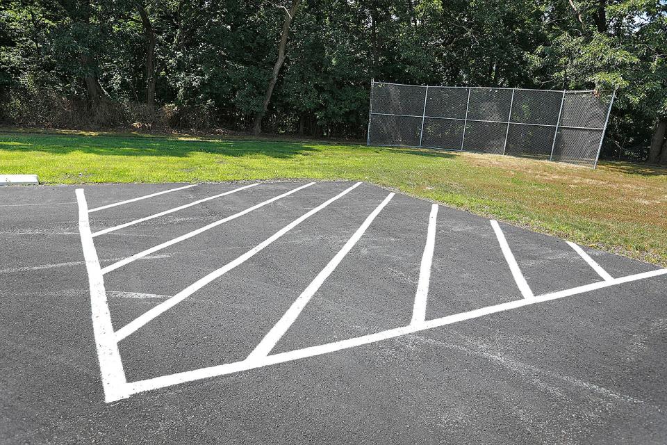 The new parking lot at the Braintree Senior Center necessitated paving over a baseball field n the adjacent playground, Thursday, July 14, 2022.