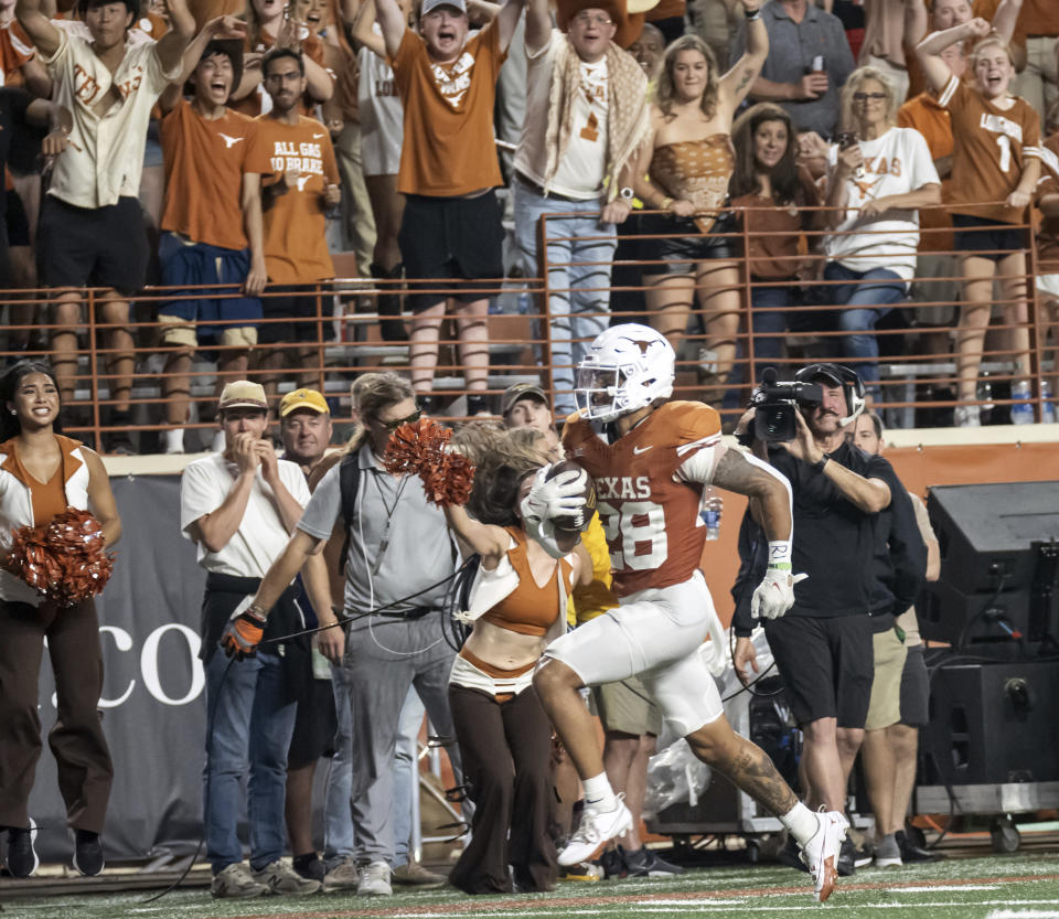 Texas defensive back JerrinThompson returns an interception of a Wyoming pass for a touchdown during the second half of an NCAA college football game Saturday, Sept. 16, 2023, in Austin, Texas. (AP Photo/Michael Thomas)