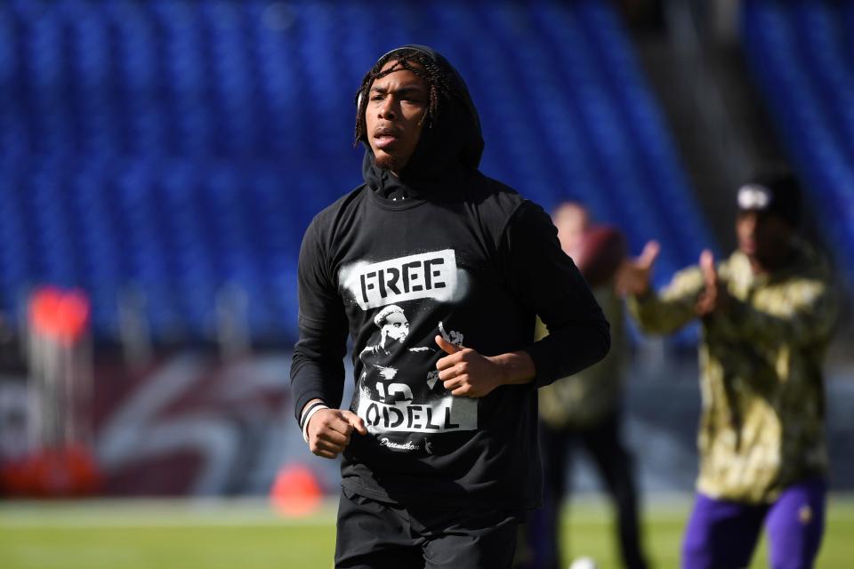 Minnesota Vikings wide receiver Justin Jefferson jogs on the field during pre-game warmups while wearing a Free Odell t-shirt.
