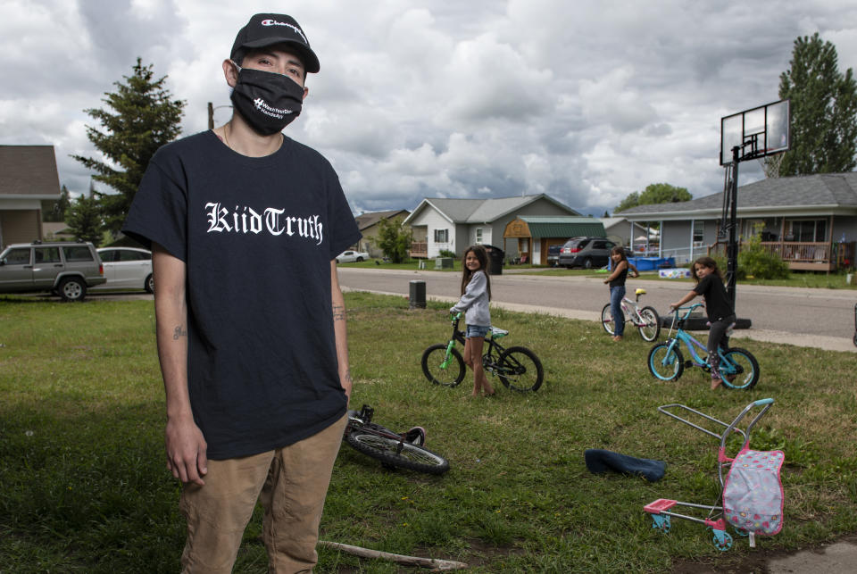 In this photo taken June 16, 2020, Artie Mendoza III, 25, also known as KiidTruth, looks on outside his home in Pablo, Montana. Mendoza created a viral TIk Tok dance and song to promote hand washing, mask wearing and social distancing among the youth on the Flathead Indian Reservation. Mendoza's children inspired him to create the dance. "And so I put two and two together, I am aiming for our youth, why not make a fun dance too." he said. (AP Photo/Tommy Martino)
