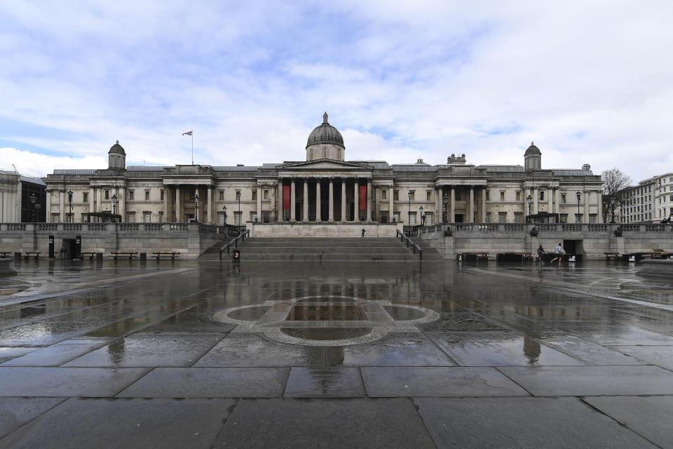 General view of The National Gallery of art, on one side of the empty Trafalgar Square, due to the Coronavirus outbreak in London, Sunday March 29, 2020. The public have been asked to self isolate, keeping distant from others to limit the spread of the contagious COVID-19 coronavirus. The new coronavirus causes mild or moderate symptoms for most people, but for some, especially older adults and people with existing health problems, it can cause more severe illness or death. (AP Photo/Alberto Pezzali)