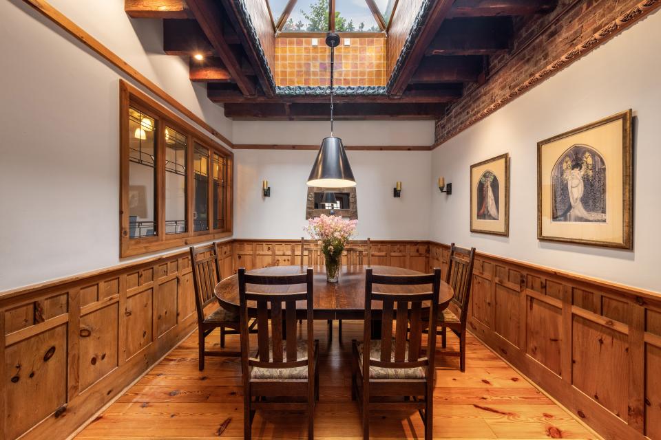 A dining area in the home beneath the skylight.