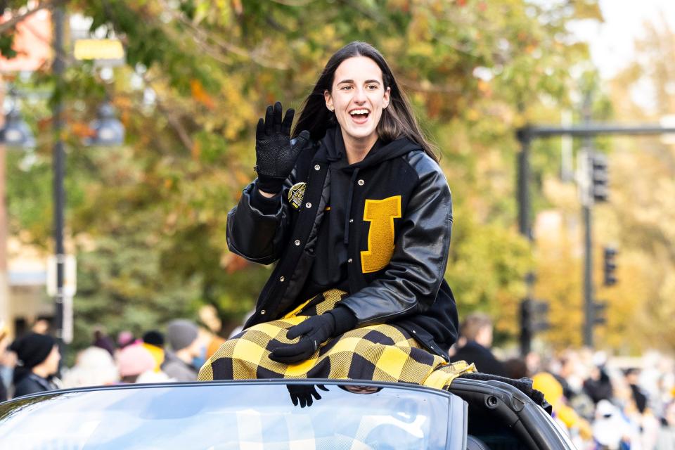 Grand Marshal Caitlin Clark waves during the University of Iowa Homecoming parade, Friday, Oct. 6, 2023, in Iowa City, Iowa.