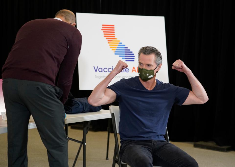 California Gov. Gavin Newsom reacts after being inoculated by Dr. Mark Ghaly, California's Health and Human Services secretary, on Thursday, April 1, 2021. Newsom was vaccinated with the new one-dose COVID-19 vaccine by Johnson & Johnson.