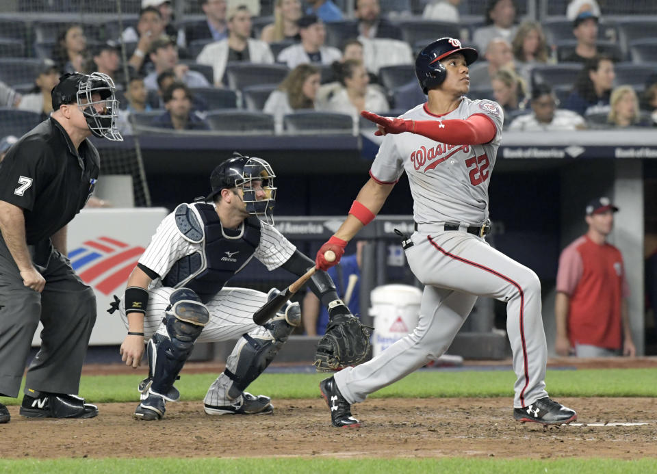 Washington Nationals’ Juan Soto watches his home run in front New York Yankees catcher Austin Romine (28) and umpire Brian O’Nora uring the seventh inning of a baseball game Wednesday, June 13, 2018, at Yankee Stadium in New York. (AP Photo/Bill Kostroun)