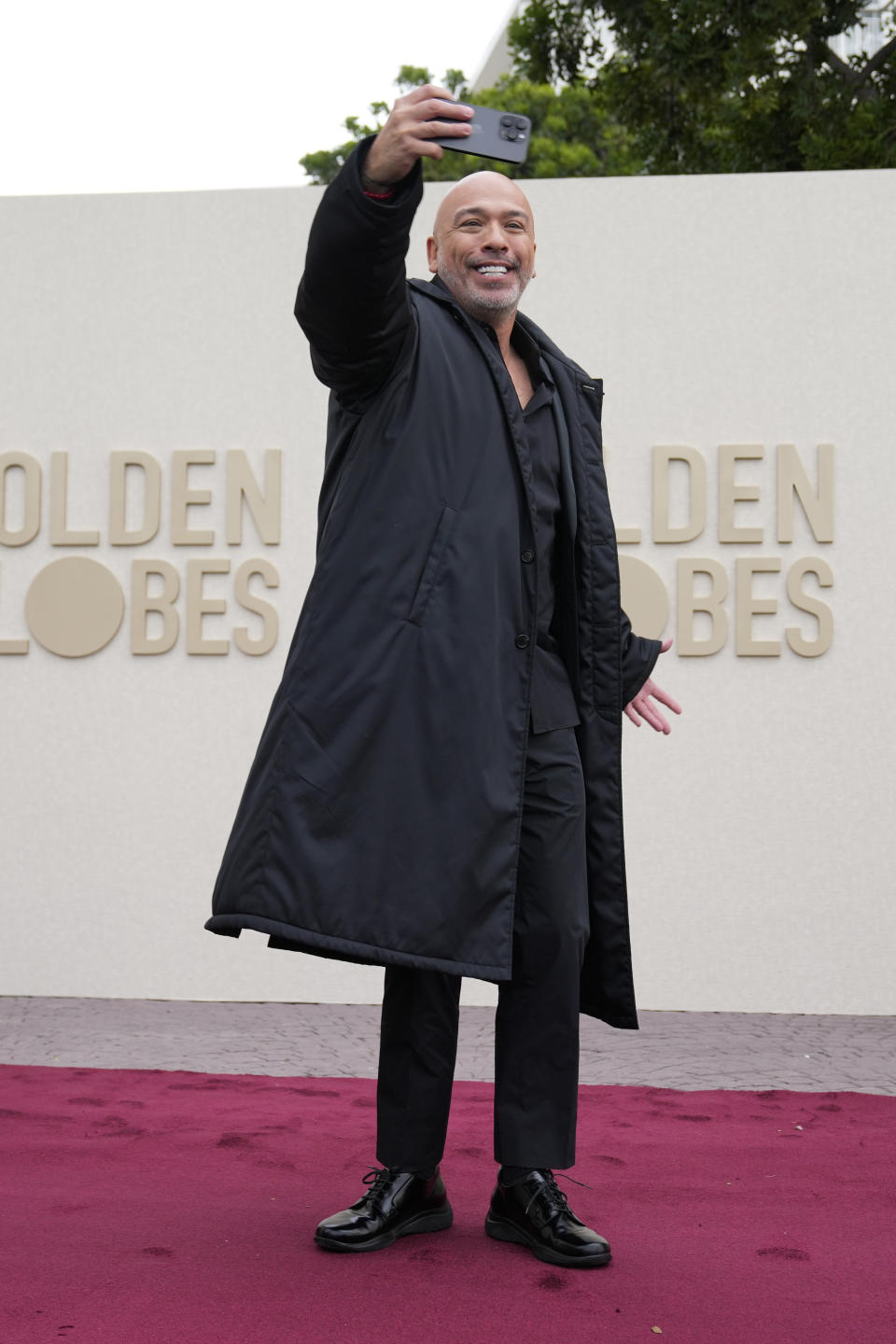 Jo Koy takes a selfie on the red carpet during the Golden Globe Awards Press Preview at the Beverly Hilton, Thursday, Jan. 4, 2024, in Beverly Hills, Calif. (AP Photo/Ashley Landis)