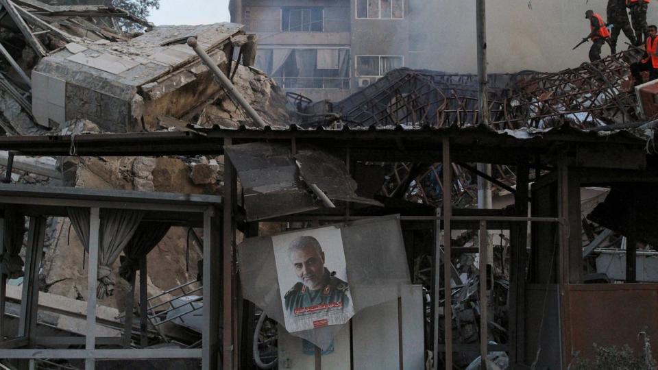 PHOTO: A picture of late senior Iranian military commander General Qassem Soleimani hangs amid rubble after what Syrian and Iranian media described as an Israeli air strike on Iran's consulate in the Syrian capital Damascus, April 1, 2024.  (Firas Makdesi/Reuters)