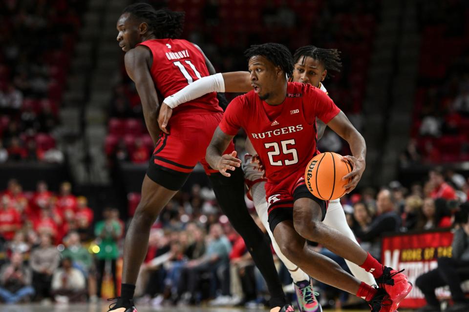 Feb 6, 2024; College Park, Maryland, USA; Rutgers Scarlet Knights guard Jeremiah Williams (25) cuts and center Clifford Omoruyi (11) sets a pick on Maryland Terrapins guard DeShawn Harris-Smith (5) during the first half at Xfinity Center. Mandatory Credit: Tommy Gilligan-USA TODAY Sports