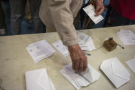 <p>A voter takes his ballot for Catalan referendum on October 1, 2017 in Barcelona, Spain. (Photograph by Jose Colon/ MeMo for Yahoo News) </p>