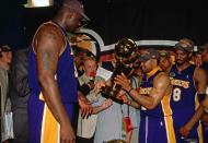 Derek Fisher #2 and Shaquille O'Neal #34 of Los Angeles Lakers present Lakers owner Jerry Buss with the Championship trophy after winning the NBA Title by defeating the Philadelphia 76ers in Game 5 of the 2001 NBA Finals played June 15, 2001 at the First Union Center in Philadelphia, Pennsylvania. (Photo by Nathaniel S. Butler/NBAE via Getty Images)