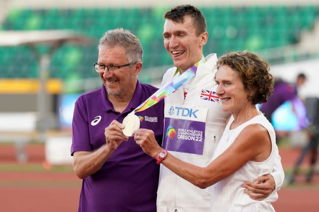 Geoff (left) and Susan Wightman pose with their son, gold medalist Jake Wightman, after the men's 1500-meter final run at the World Athletics Championships. (Photo: via Associated Press)