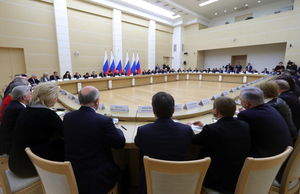 Russian President Vladimir Putin, background center, speaks as he chairs a meeting on drafting constitutional changes at the Novo-Ogaryovo residence outside Moscow, Russia, Thursday, Jan. 16, 2020. (Mikhail Klimentyev, Sputnik, Kremlin Pool Photo via AP)