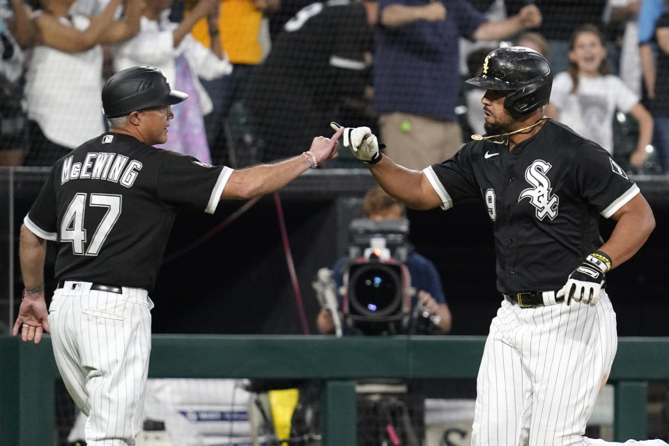 Chicago White Sox's Jose Abreu, right, celebrates with third base coach Joe McEwing after hitting a three-run home run during the sixth inning of the team's baseball game against the Houston Astros in Chicago, Saturday, July 17, 2021. (AP Photo/Nam Y. Huh)