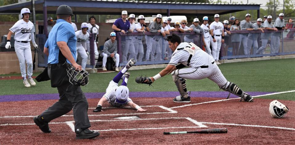 Wylie's K.J. Long slides around the tag of Lubbock High catcher Ivan McGwiere for a run in the fourth inning. Long scored on Tye Briscoe's two-run single after doubling in two runs earlier in the inning.