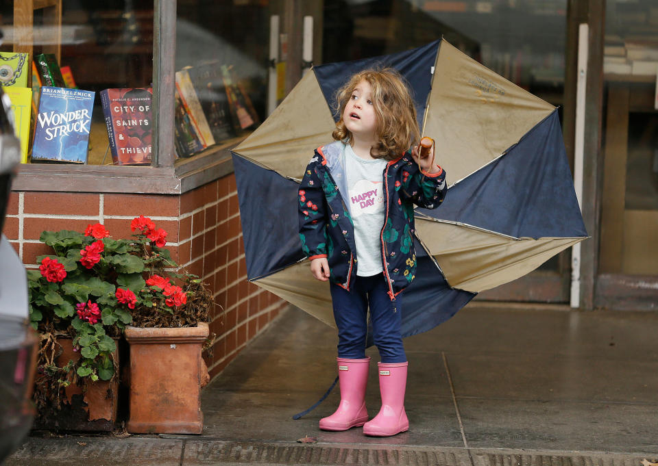 <p>Three-year-old Emerson Cassidy takes cover from the rain in a storefront entry on Feb. 20, 2017, in San Anselmo, Calif. Heavy downpours are swelling creeks and rivers and bringing threats of flooding in California’s already soggy northern and central regions. (AP Photo/Eric Risberg) </p>