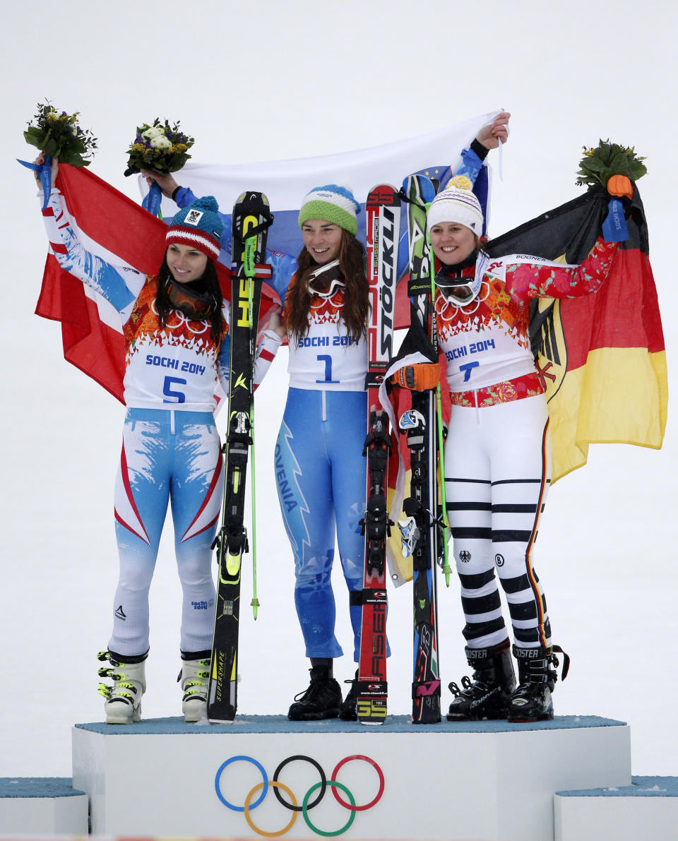 Women's giant slalom winners, from left, Austria's Anna Fenninger (silver), Slovenia's Tina Maze (gold) and Germany's Viktoria Rebensburg (bronze), pose for photographers on the podium at the Sochi 2014 Winter Olympics, Tuesday, Feb. 18, 2014, in Krasnaya Polyana, Russia. (AP Photo/Christophe Ena)