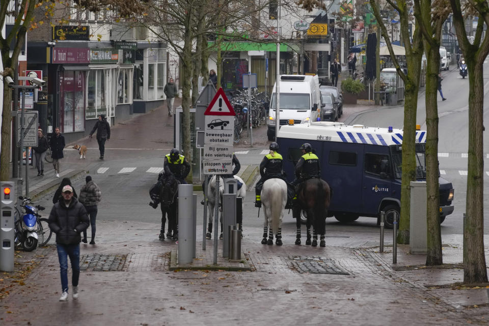 Police patrol the city center after a demonstration against COVID-19 restrictions and lockdown was banned in Nijmegen, eastern Netherlands, Sunday, Nov. 28, 2021. (AP Photo/Peter Dejong)