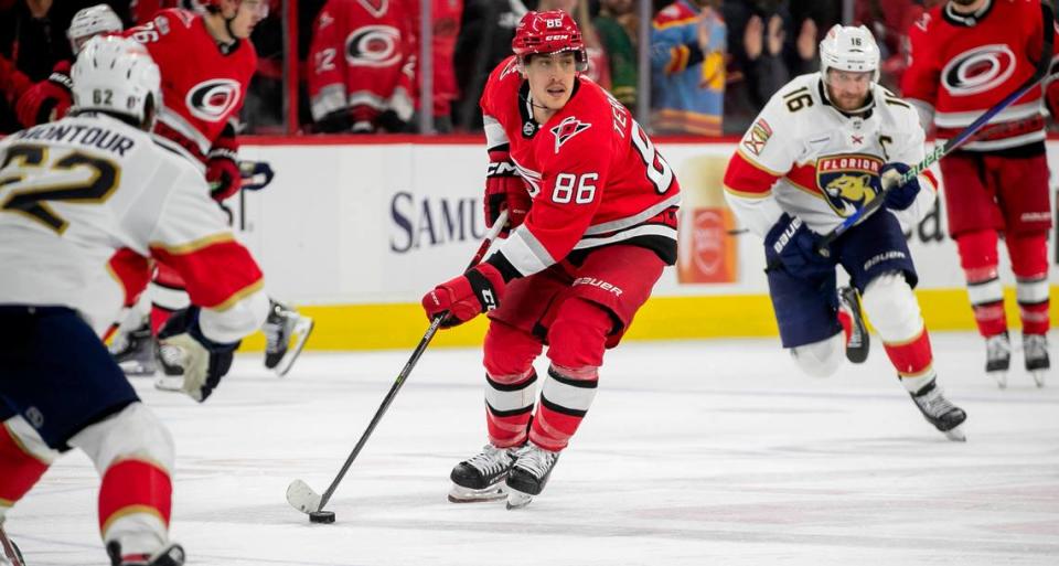 The Carolina Hurricanes Teuvo Teravainen (86) moves the puck between the Florida Panthers Brandon Montour (62) and Aleksander Barkov (16) in the fourth overtime period in Game 1 of the Eastern Conference Finals on Friday, May 19, 2023 at PNC Arena in Raleigh. Teravainen saw his first playoff action in a month after recovering from a broken hand.