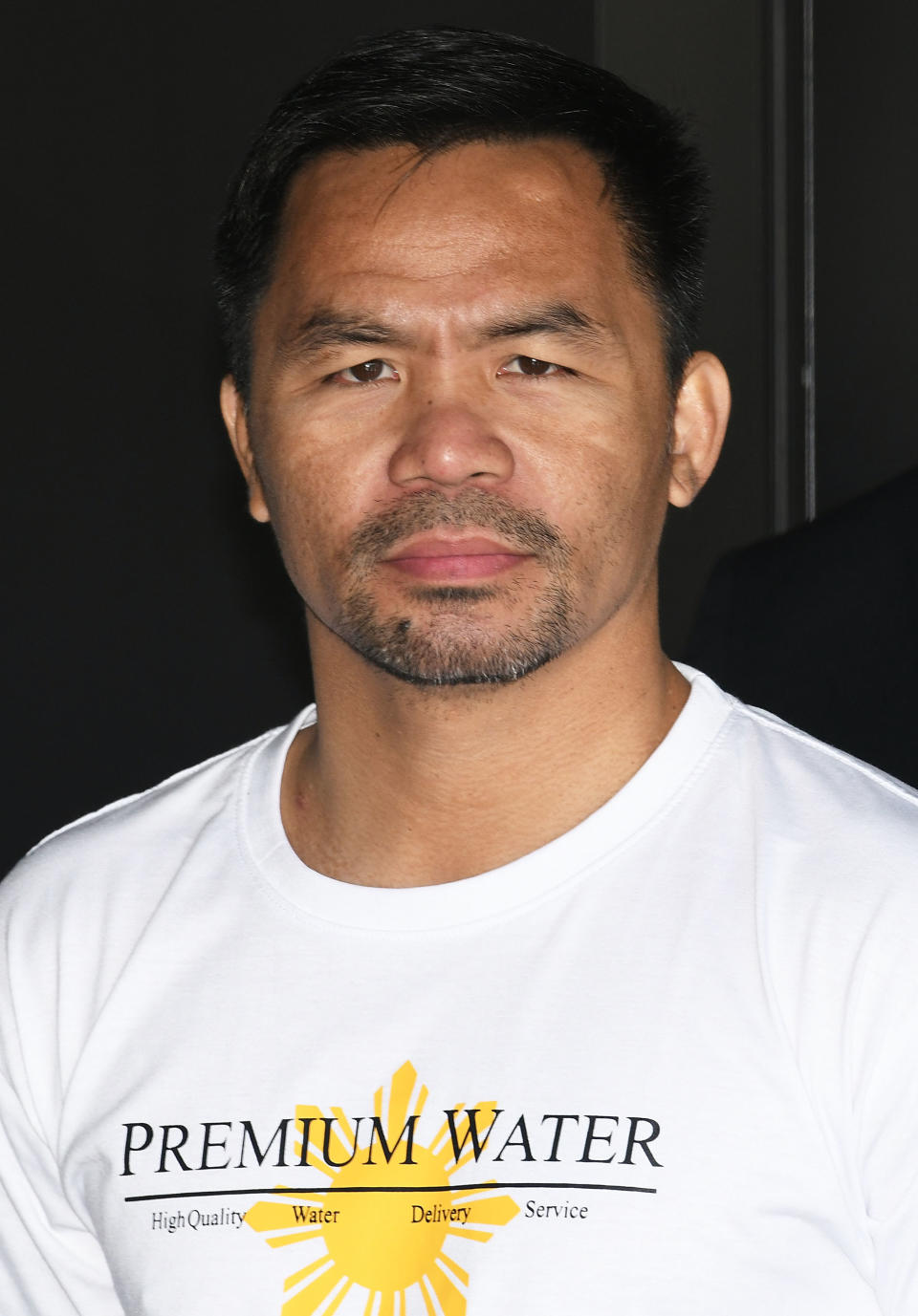 A close-up of Manny wearing a t-shirt that says "Premium Water"