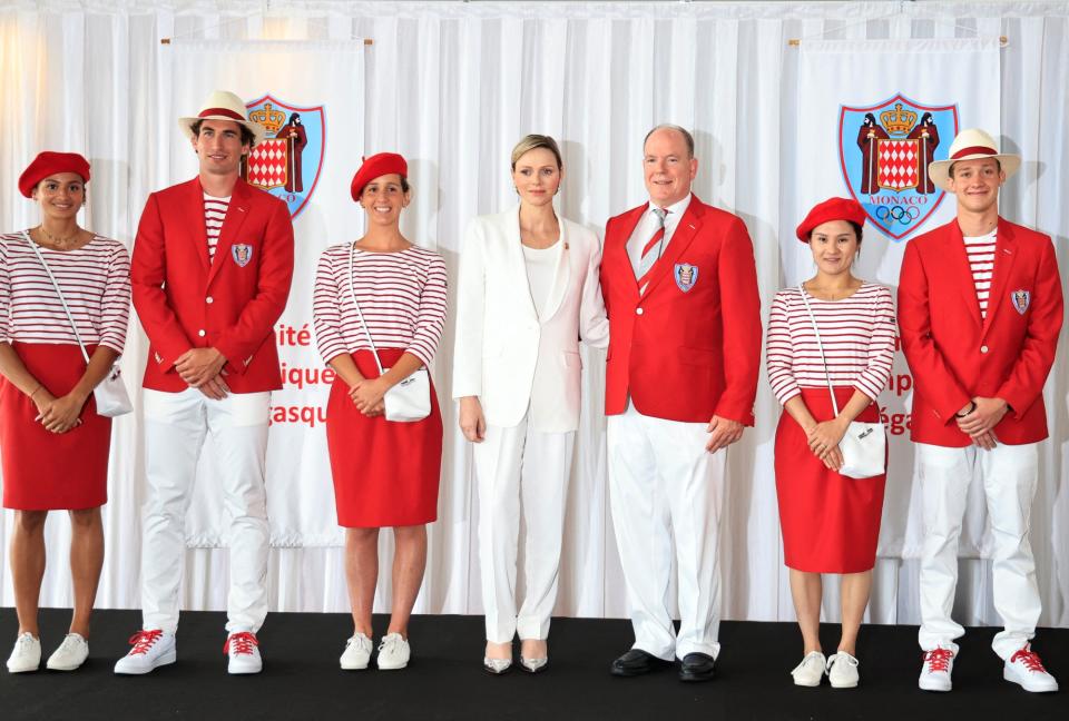 Prince's Albert II of Monaco (3R) and Princess Charlene of Monaco (3L) pose for a picture with (from L) athletes Marie-Charlotte Gastaud, Quentin Antognelli, Lisa Pou, Xiaoxin Yang and Theo Druenne during the presentation of Monaco's Olympic team for the Paris 2024 Games, in Monaco on June 27, 2024. (Photo by Valery HACHE / AFP) (Photo by VALERY HACHE/AFP via Getty Images)