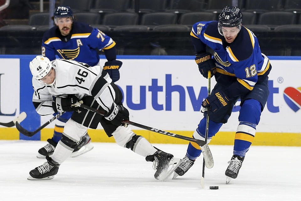 Los Angeles Kings' Blake Lizotte (46) and St. Louis Blues' Zach Sanford (12) vie for the puck during the second period of an NHL hockey game Wednesday, Feb. 24, 2021, in St. Louis. (AP Photo/Scott Kane)