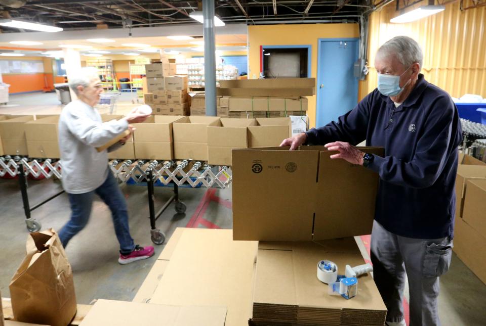 Volunteers Peter Lombardo, at right, and Judy Phillips create and pack food boxes for the Goshen area Tuesday, Jan. 31, 2023, at the Food Bank of Northern Indiana in South Bend.