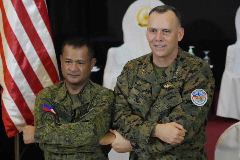 U.S. Marine Corps Major General Eric Austin, right, U.S. exercise director representative, and Philippine Army Major General Marvin Licudin, Philippine exercise director pose after the opening ceremonies of a joint military exercise flag called "Balikatan," a Tagalog word for "shoulder-to-shoulder," at Camp Aguinaldo military headquarters Tuesday, April 11, 2023, in Quezon City, Philippines. The United States and the Philippines on Tuesday launch their largest combat exercises in decades that will involve live-fire drills, including a boat-sinking rocket assault in waters across the South China Sea and the Taiwan Strait that will likely inflame China. (AP Photo/Aaron Favila)
