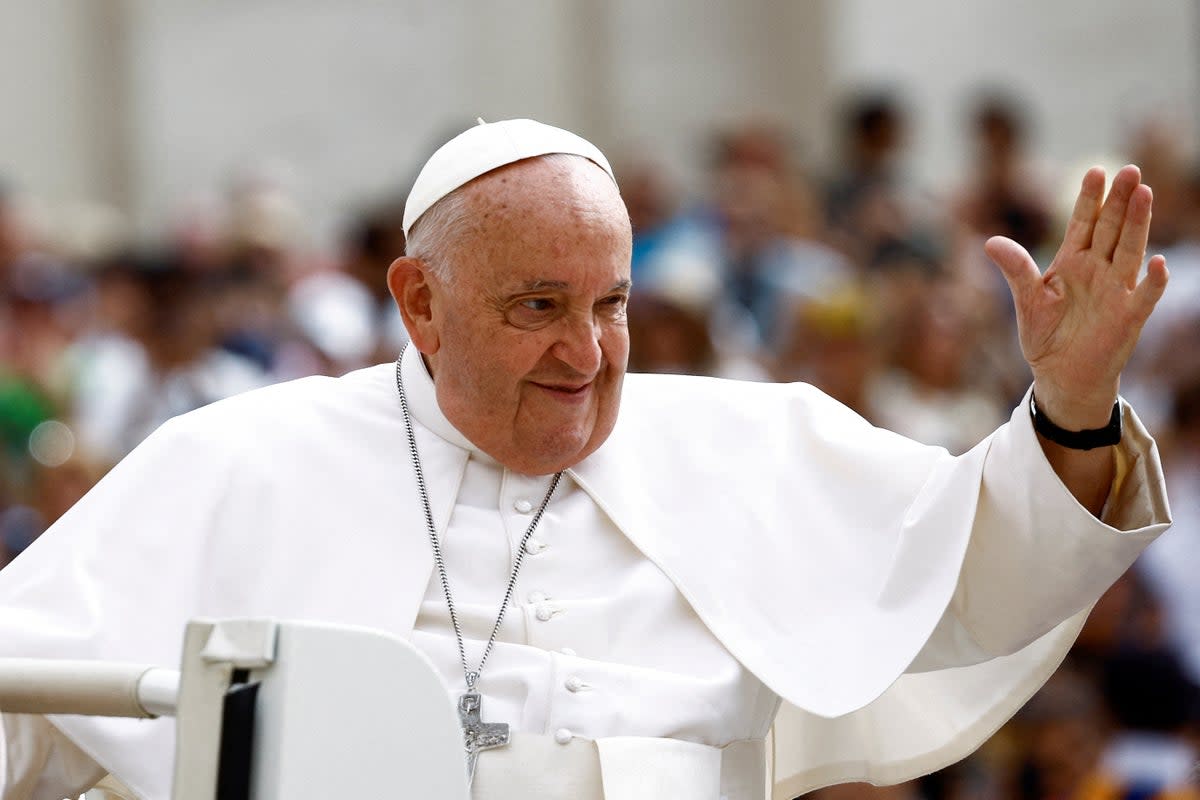 Pope Francis greets people as he arrives for the weekly general audience at Saint Peter's Square at the Vatican (Reuters)