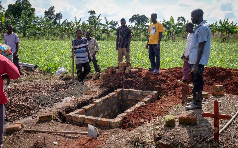 Relatives of a woman who died from Ebola prepare her grave in Kijavuzo village, Mubende district, Uganda - Hajarah Nalwadda/AP