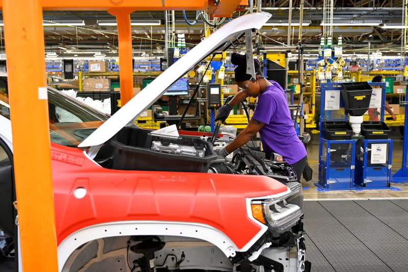 FILE PHOTO: Components are installed around the engine on the assembly line at the General Motors (GM) manufacturing plant in Spring Hill