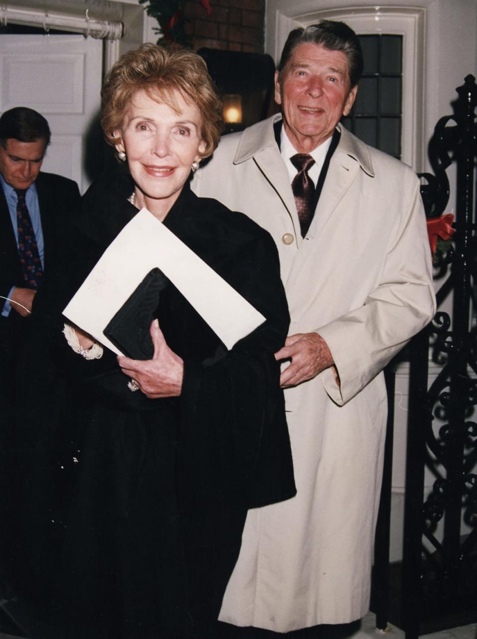 Ronald Reagan standing behind Nancy in 1992