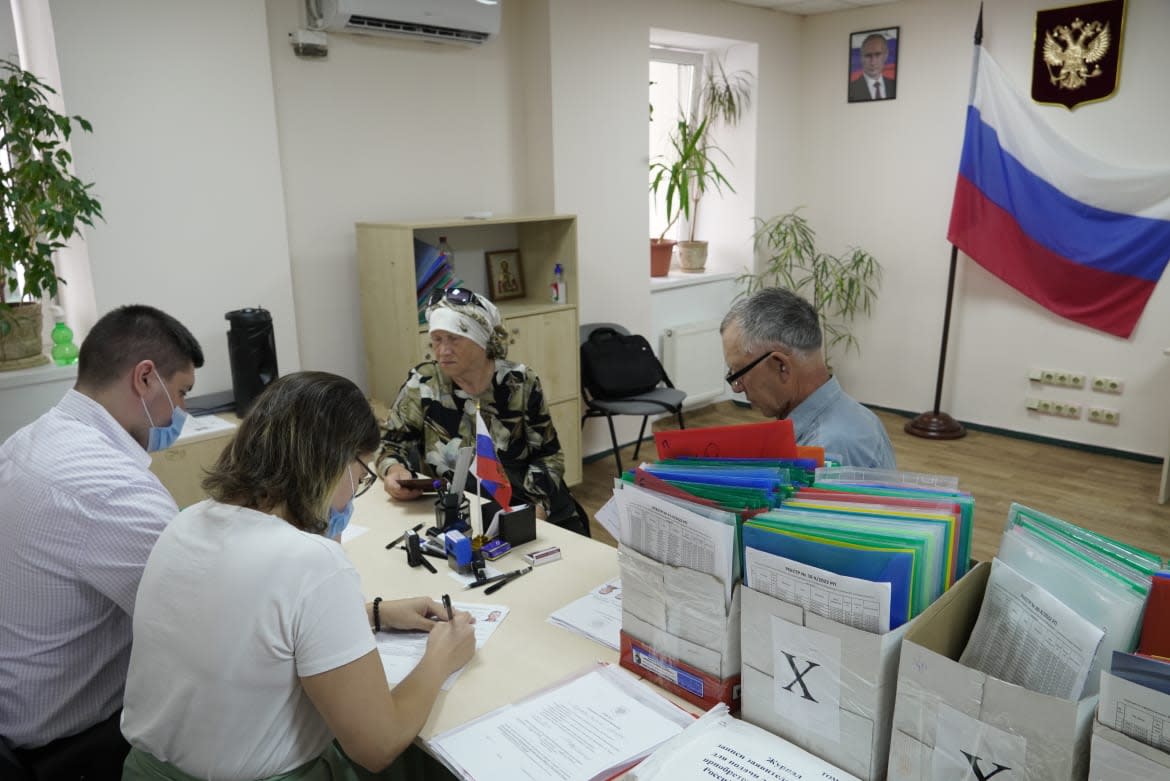 <div class="inline-image__caption"><p>People receive Russian passports at a centre in Kherson after Russian President Vladimir Putin made it easier for residents of Kherson and Melitopol regions to get passports. July 21, 2022. </p></div> <div class="inline-image__credit">Anadolu Agency via Getty</div>