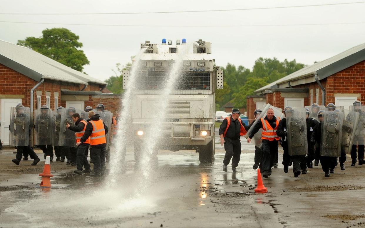 Police training with the type of water cannon bought by Boris Johnson when he was London Mayor - PA Archive