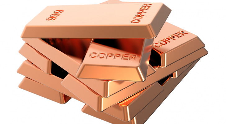 Copper ingots in a stack on a white background. Copper stocks.