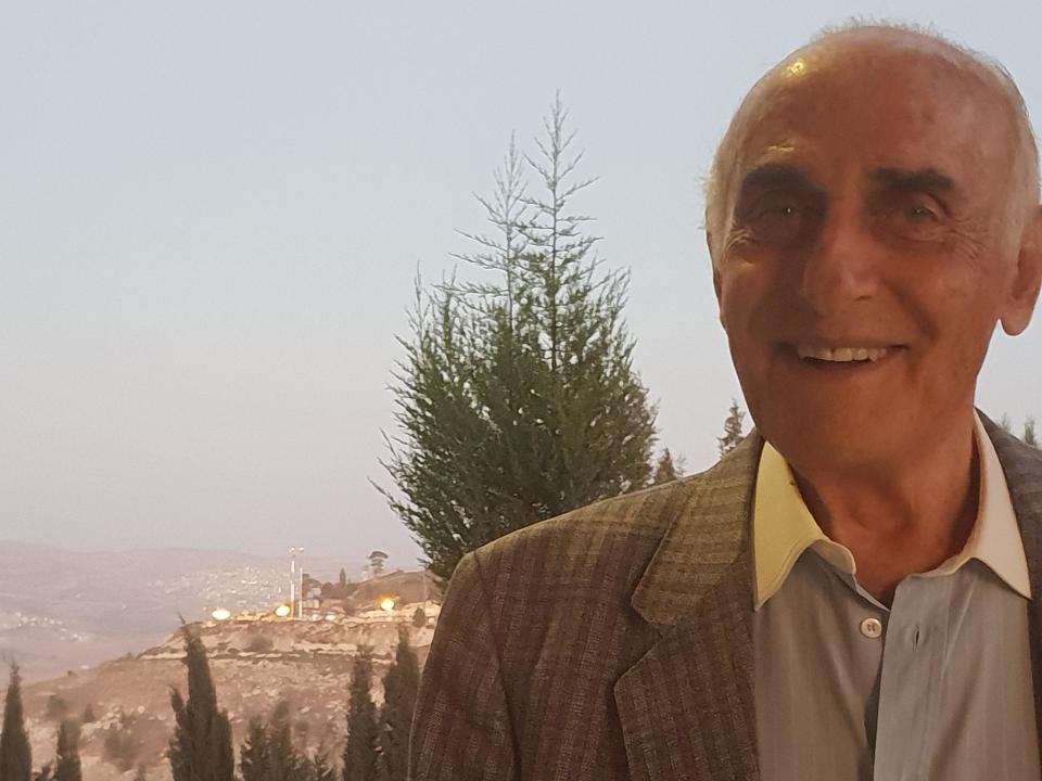 So far and yet so close: the lights of a nearby Jewish settlement shine over Munib Musri's shoulder as he stands on the edge of his vast palace of treasures near Nablus: Nelofer Pazira