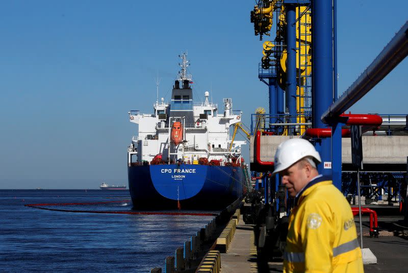 FILE PHOTO: Oil is pumped into an oil tanker at the Ust-Luga oil products terminal in the settlement of Ust-luga