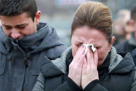 Mourners cry as a cortege escorts a car carrying coffin of Oliver Ivanovic travels to the northern outskirts of Kosovska Mitrovica, Kosovo, January 17, 2018. REUTERS/Djordje Kojadinovic