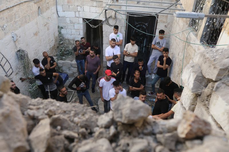 People gather at the scene where two Palestinian militants were killed during clashes with Israeli forces in a raid, in Nablus