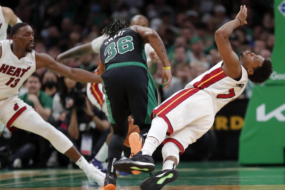 Miami Heat's Kyle Lowry (7) fouls Boston Celtics' Marcus Smart (36) during the first half of Game 6 of the NBA basketball playoffs Eastern Conference finals Friday, May 27, 2022, in Boston. (AP Photo/Michael Dwyer)