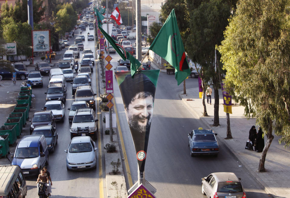 FILE-- In this August 25, 2009 file photo, a picture of Shiite Muslim spiritual leader, Imam Moussa Sadr, who disappeared on a trip to Libya in 1978, is seen attached to a light pole in Beirut's southern suburb of Dahiyah, Lebanon. An Arab economic development summit that Lebanon is hosting this weekend has been marred by controversy days before delegates arrive. (AP Photo/Hussein Malla, File)